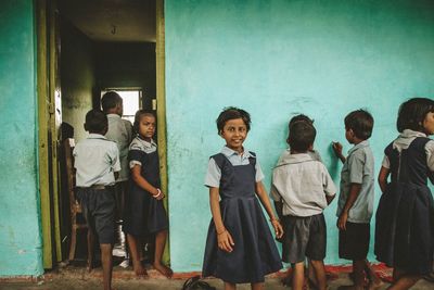 Children standing against wall