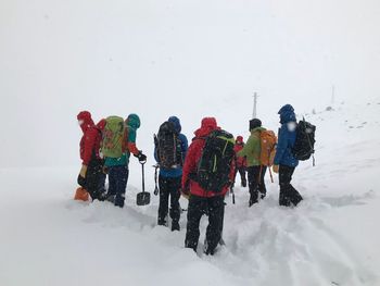 People on snowcapped mountains during winter