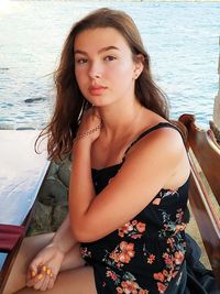 Portrait of beautiful young woman sitting in boat