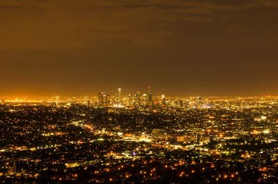 High angle view of illuminated buildings against sky at night