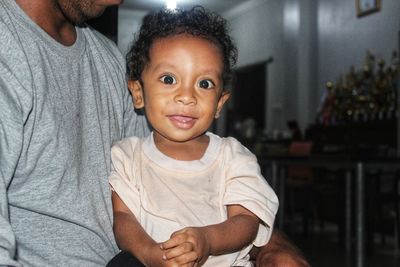 Portrait of cute boy with baby at home