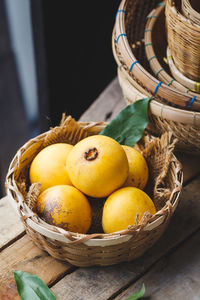 High angle view of fruits in basket on table