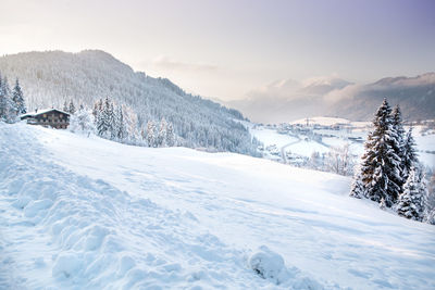 Snow covered landscape against sky
