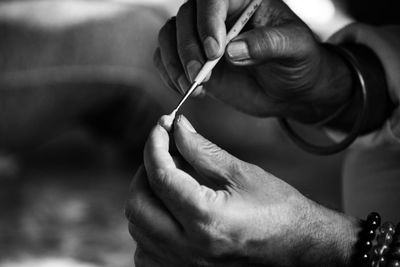 Cropped hand of man playing guitar