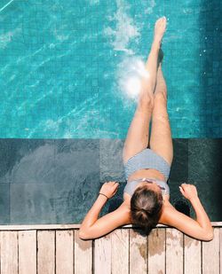 High angle view of woman sitting at poolside