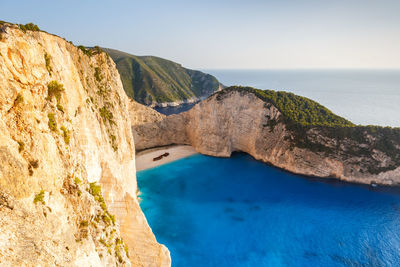 Scenic view of sea and rock formation against sky