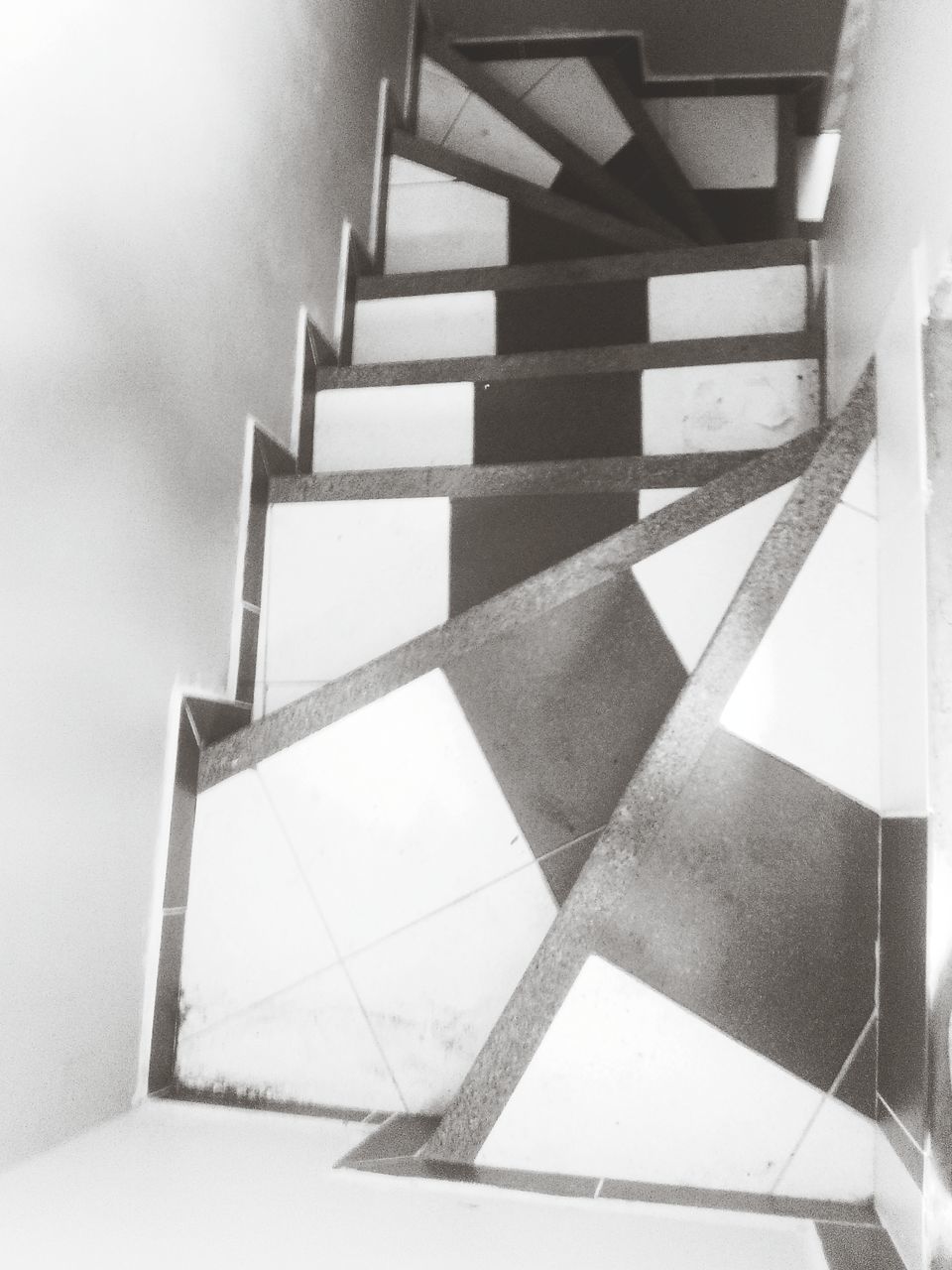 indoors, architecture, built structure, tiled floor, shadow, steps, flooring, wall - building feature, steps and staircases, staircase, pattern, empty, corridor, railing, sunlight, the way forward, design, day, high angle view, in a row