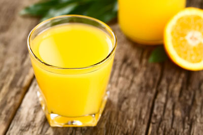 High angle view of yellow drink on table