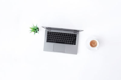 Close-up of laptop on table against white background