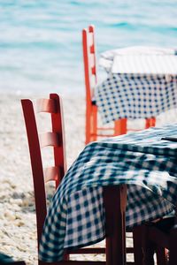 Empty chairs and tables at beach