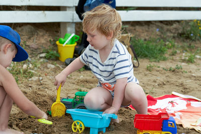 High angle view of boy playing with toys on field