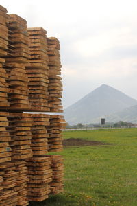 Stack of stone wall on field against sky