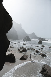 Scenic view of sea and mountains against sky