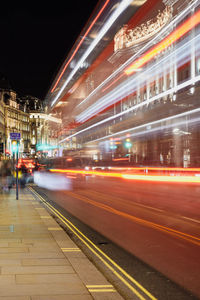 Light trails on road in city at night