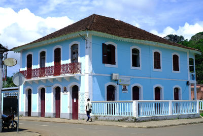 Road by building against sky