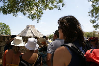 Rear view of people against sky