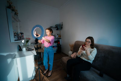 Mother and daughter record video use smartphone