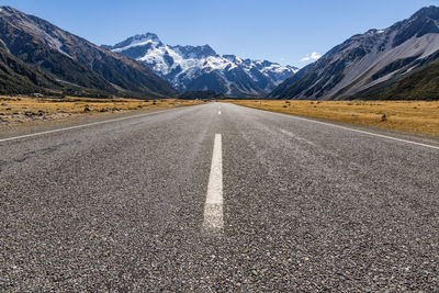 Road amidst mountains against sky