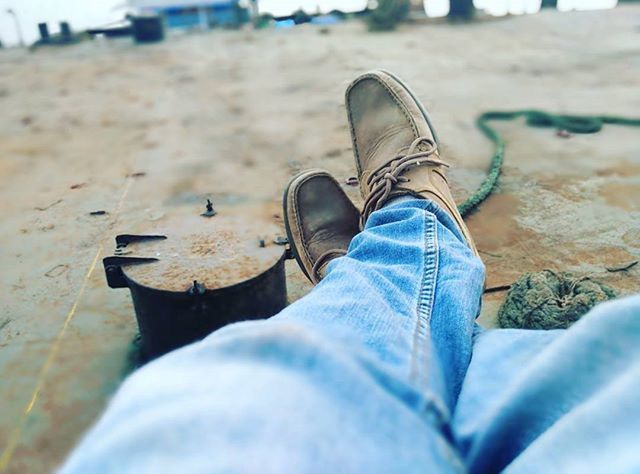 low section, shoe, person, footwear, focus on foreground, selective focus, personal perspective, jeans, human foot, close-up, lifestyles, relaxation, day, canvas shoe, leisure activity, sand, outdoors