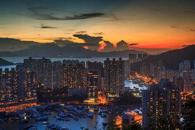 Aerial view of city lit up at sunset