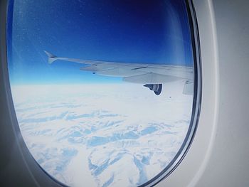 Cropped image of airplane flying over mountain