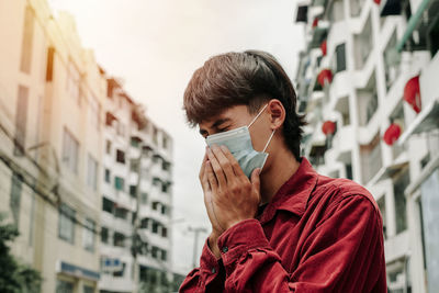 Portrait of young man drinking outdoors