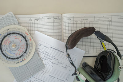 Close-up of headset and documents on table