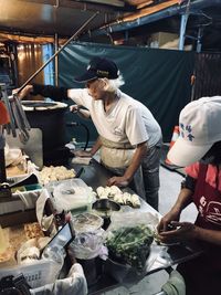 People working at market stall