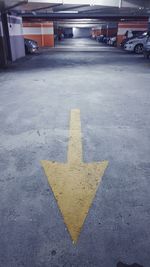 Arrow symbol on road in parking lot