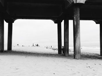 People on beach below view of sea