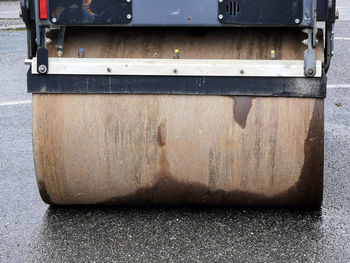 Closeup view of a rusty roll compactor used for road repair