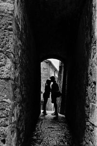 Full length of woman walking in tunnel