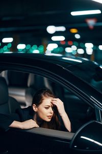 Thoughtful woman sitting in car