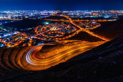 Aerial view from amirat viewpoint on wavy road in muscat at night