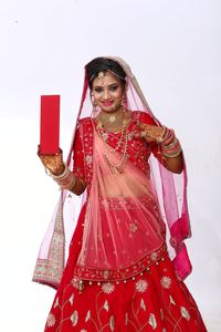 Portrait of a woman against red background