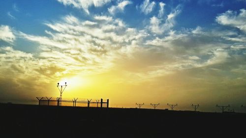 Silhouette windmill against sky during sunset