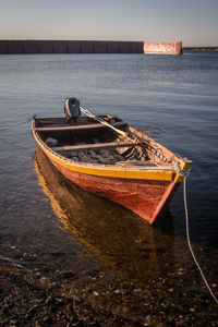 Boat moored in sea against sky