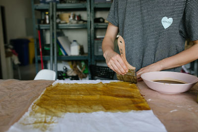 Midsection of man preparing food at home