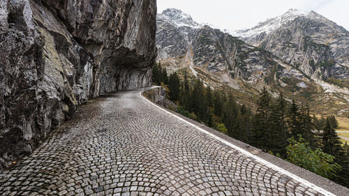 Footpath amidst rocks against mountains