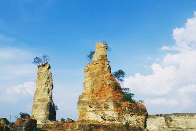 Low angle view of rock formations against sky