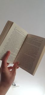 Cropped image of hand holding book