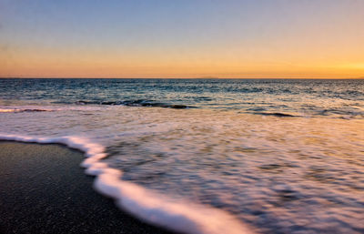 Scenic view of sea against clear sky during sunset