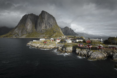 Scenic view of sea and mountains against sky