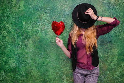 Midsection of woman with red roses