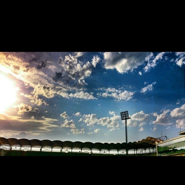 sky, cloud - sky, silhouette, cloud, cloudy, sunset, street light, low angle view, nature, tranquility, sunlight, beauty in nature, scenics, outdoors, no people, built structure, tranquil scene, sun, railing, blue