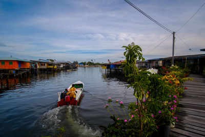 Two men leaving by motorboat