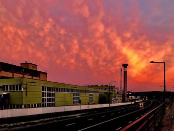 Train on railroad tracks against sky during sunset