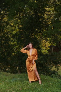 Woman standing by tree