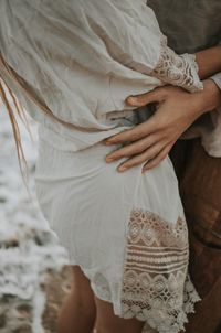 Midsection of woman holding umbrella standing at home