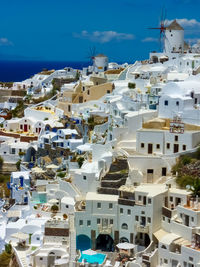 High angle view of buildings against blue sky